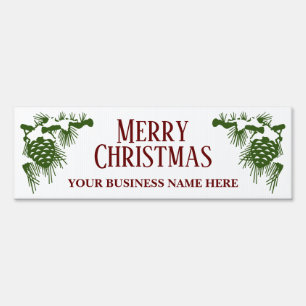 Christmas yard sign with snow covered pinecones