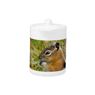 Chubby cute chipmunk on on wood stump teapot