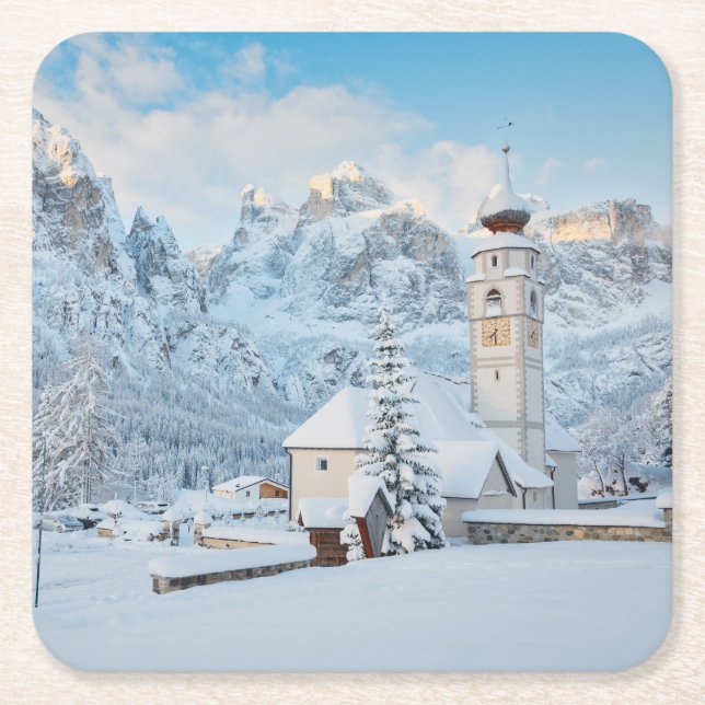 Church covered in snow with mountain background square paper coaster (Front)