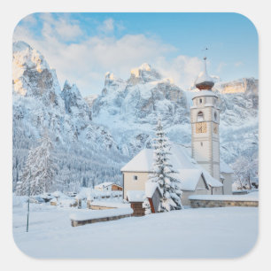 Church covered in snow with mountain background square sticker