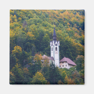 Church in a fall forest in Slovenia Magnet