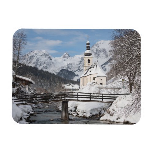 Church in the snow with Alps mountains in winter Magnet