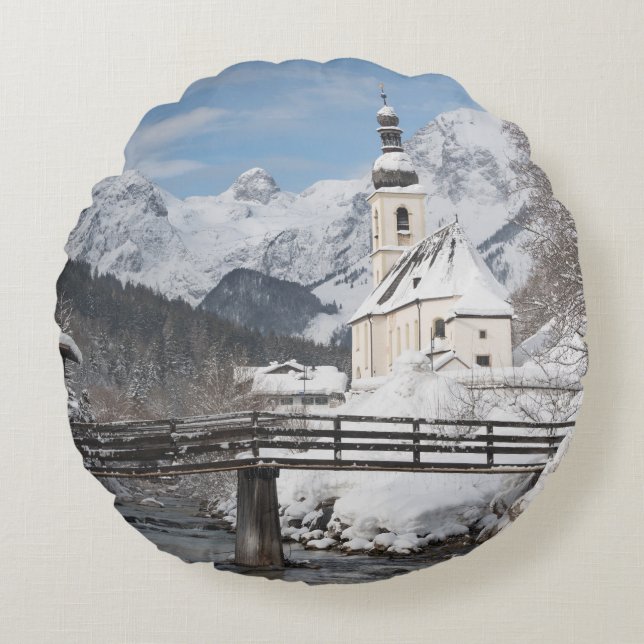 Church in the snow with Alps mountains in winter Round Pillow (Front)