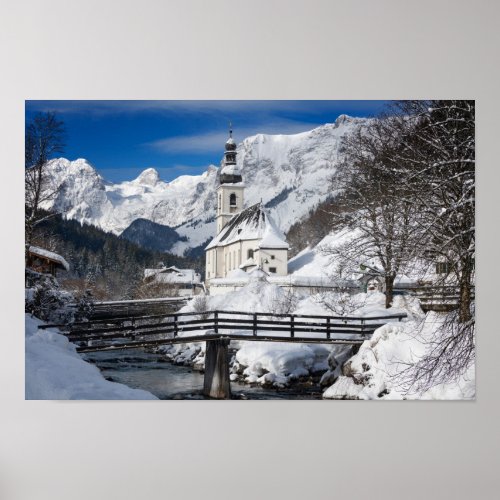 Church in the snow with Alps mountains Poster