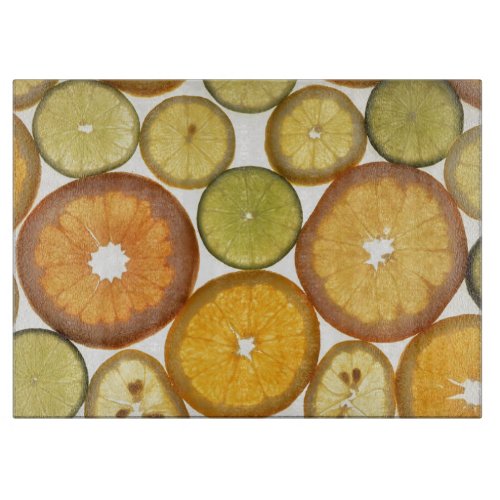 Citrus fruit slices orange green yellow white cutting board