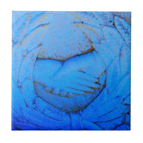 clasped hands blue tile