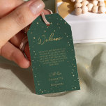 Classic Christmas Destination Wedding Welcome Gift Tags<br><div class="desc">This classic Christmas destination wedding welcome gift tags features a clean, bright white backdrop with simple, minimalist black and gold lettering and handwritten calligraphy accents. Embellishments of beautiful and classic green and red Christmas wreaths with delicate gold features create a perfect winter holiday aesthetic while maintaining a polished elegance for...</div>
