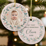 Classic Floral Frame Pink Baby's First Christmas Ceramic Ornament<br><div class="desc">Celebrate a once-in-a-lifetime milestone with this Classic Floral Frame Baby’s First Christmas Ornament. Featuring your baby’s photo framed by a delicate watercolor wreath of muted greens, blush pink berries, and ivory blossoms, this keepsake is printed on smooth porcelain with a warm blush background. The back showcases “My Very First Christmas”...</div>