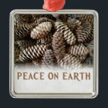 Classic Holiday Pine Cone Peace On Earth Metal Ornament<br><div class="desc">Festive,  earthy pine cones set off this classic,  elegant design wishing Peace On Earth.</div>