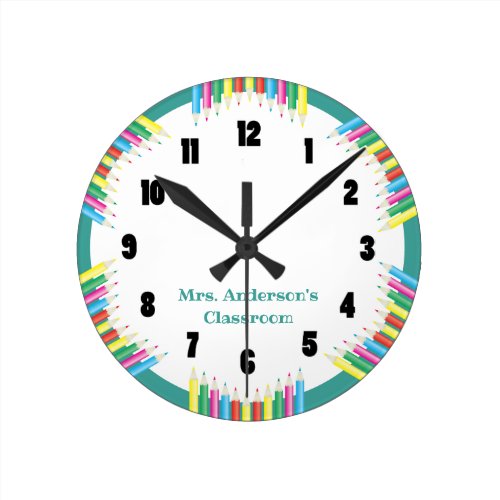 Classroom Clock Colored Pencils - This classroom clock offers a very colorful design. A graphic of colored pencils border the outside of the clock and a teal and white background. Custom text allows you to add the teacher's name.