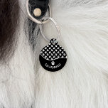 Classy Black And White Dog Paws Pattern & Name Pet ID Tag<br><div class="desc">This stylish black and white color design is split with a decorative wave shape. On the bottom there is a curved personalizable text area for the name of the pet while on the top there is a pattern of white dog paw prints on a black background color. On the back...</div>