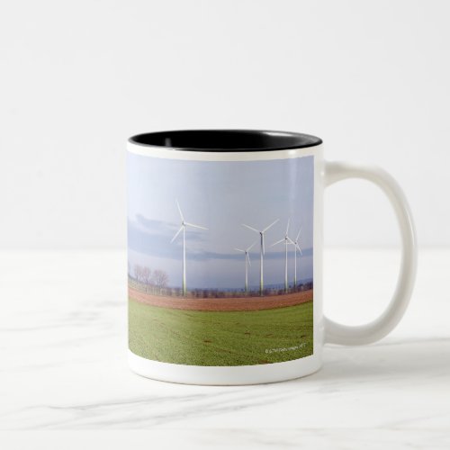 Clean energy by many wind turbines on fields Two_Tone coffee mug