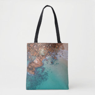 Clear blue sea and rocks tote bag
