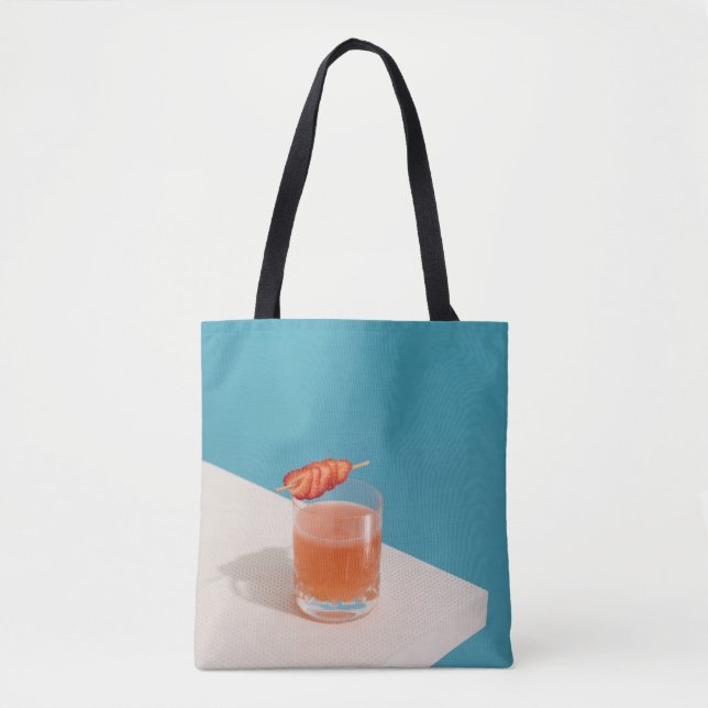 Clear drinking glass with brown liquid tote bag (Front)
