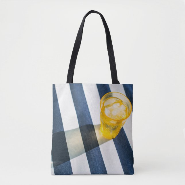 Clear drinking glass with yellow liquid tote bag (Front)
