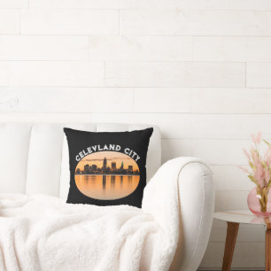 Cleveland city sunset skyline football shape throw pillow