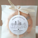 Cleveland Skyline | Wedding Welcome Message Classic Round Sticker<br><div class="desc">Enhance your wedding welcome packages or event party favors with a custom set of welcome stickers! These elegant yet minimal-style stickers are tailored for a wedding taking place in the beautiful city of Cleveland, Ohio. They feature a modern deco skyline with the name of the city integrated underneath. All elements...</div>