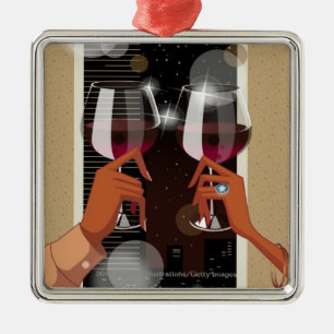 Close-up of a couple's toasting with wine glasses metal ornament