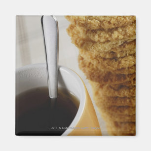 Close-up of a cup of coffee with cookies magnet