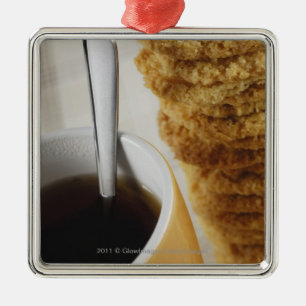 Close-up of a cup of coffee with cookies metal ornament