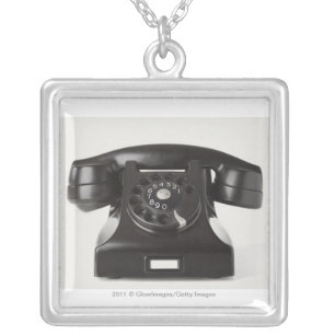 Close-up of a rotary phone silver plated necklace
