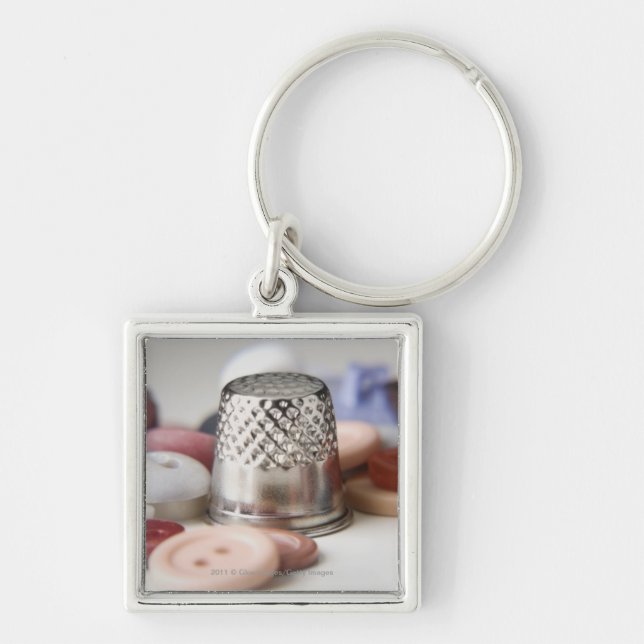 Close-up of buttons with a metal cap keychain (Front)