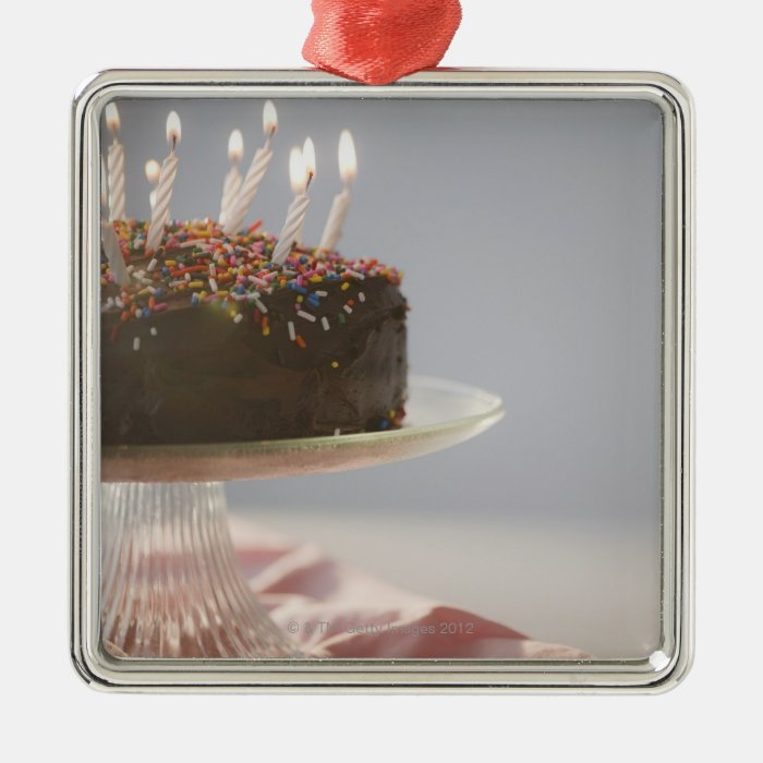 Close up of chocolate birthday cake with candles christmas tree ornament