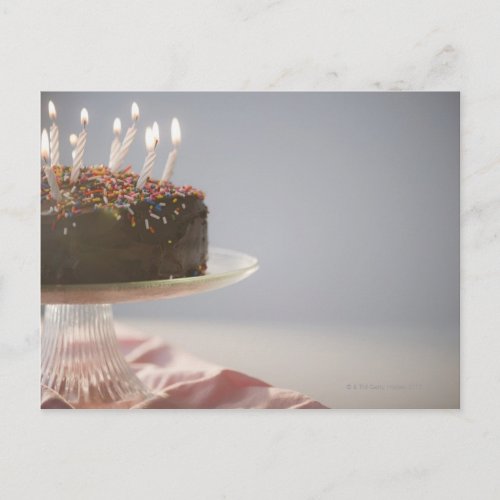 Close up of chocolate birthday cake with candles postcard