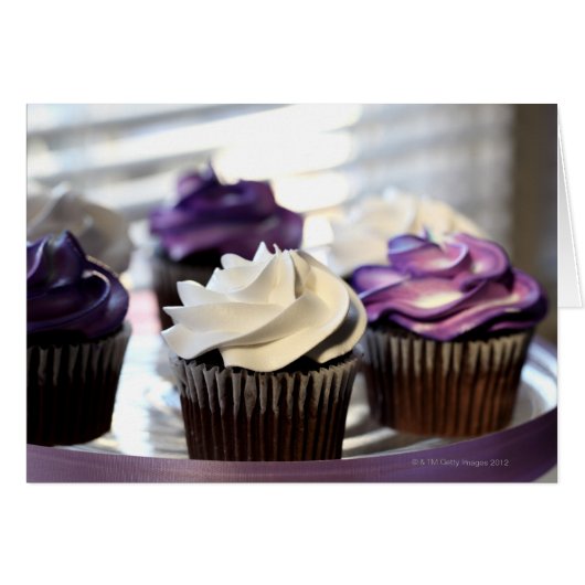 Close-up of cupcakes with selective focus on cards (Front Horizontal)
