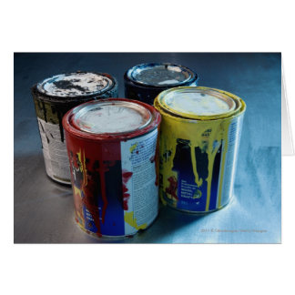 Close-up of four paint cans