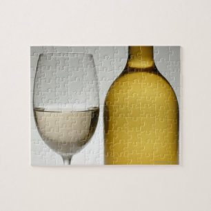 Close up of glass of white wine and wine bottle jigsaw puzzle