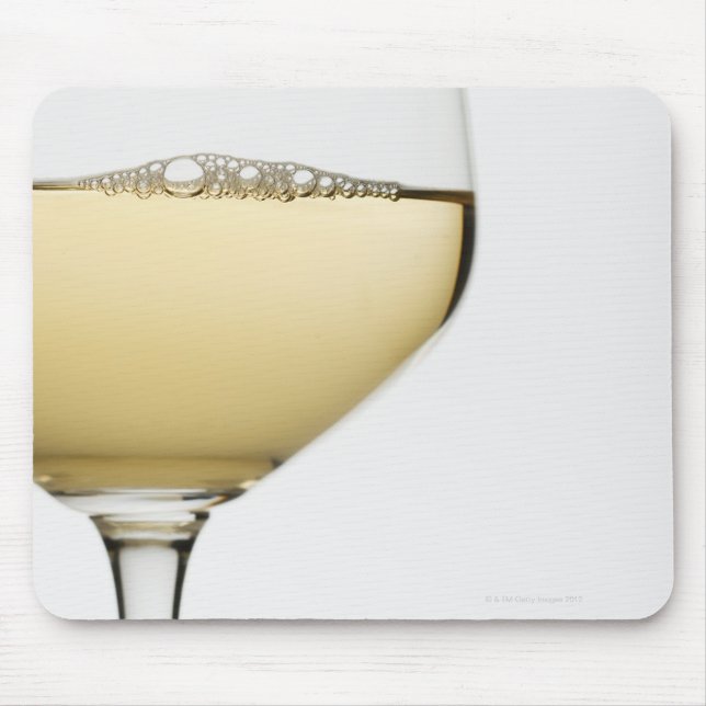 Close up of glass of white wine on white mouse pad (Front)