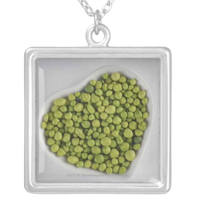 Close-up of green pebbles in a heart shape bowl silver plated necklace (Front)