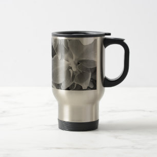 Close up of orchid blossoms in gray scale travel mug