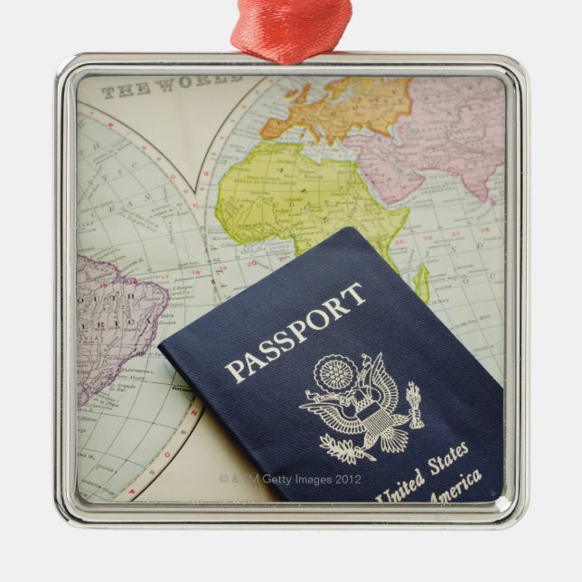 Close-up of passport lying on map metal ornament (Front)