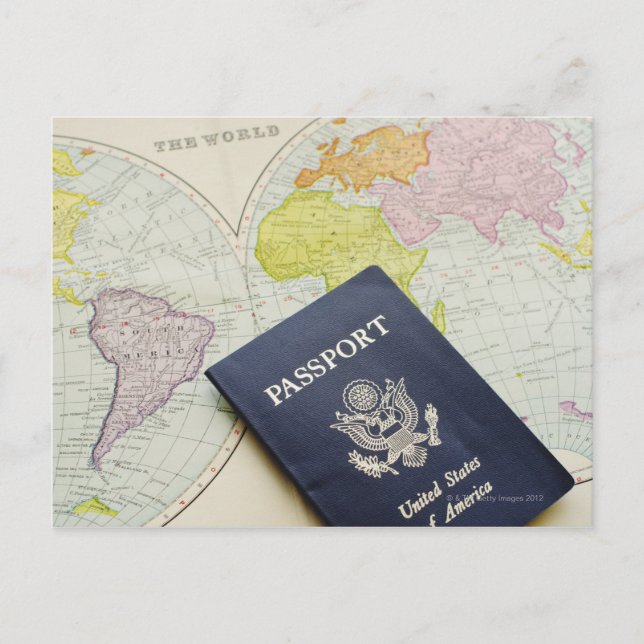 Close-up of passport lying on map postcard (Front)
