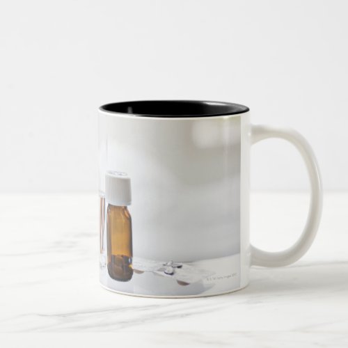 Close up of pill bottle with sick woman in Two_Tone coffee mug