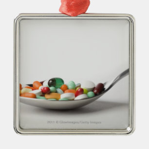 Close-up of pills in a spoon metal ornament