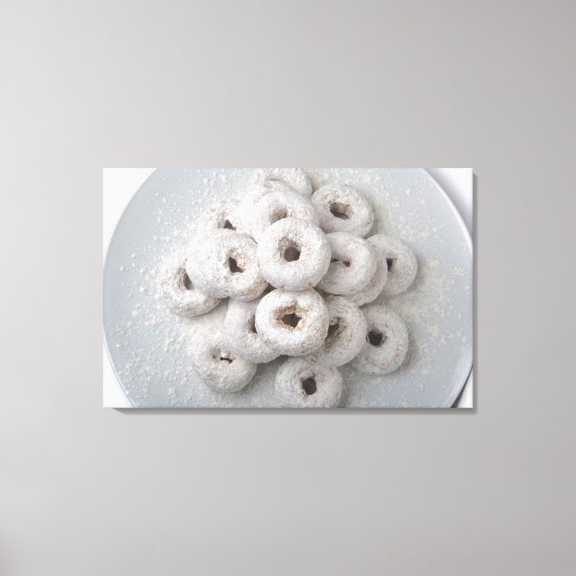 Close-up of powdered doughnuts in a plate canvas print (Front)