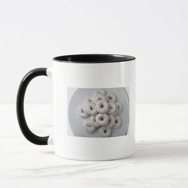 Close-up of powdered doughnuts in a plate mug (Left)