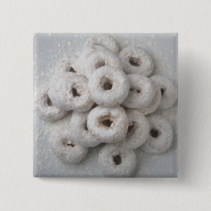 Close-up of powdered doughnuts in a plate pinback button