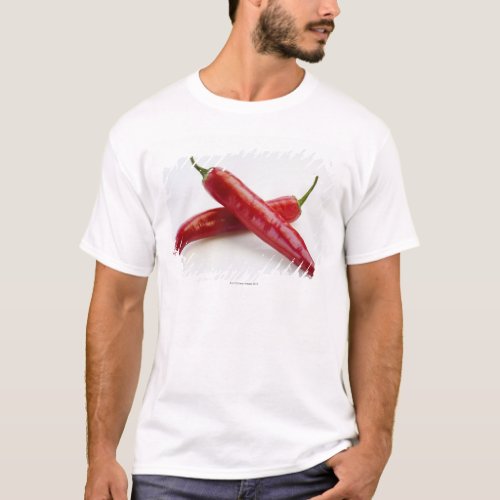 Close up of red chili peppers on white T_Shirt