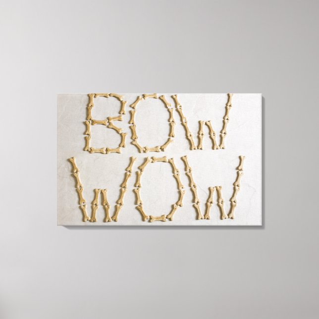 Close-up of texts BOW WOW made with dog biscuits Canvas Print (Front)