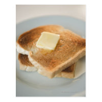 Close up of toasts with butter on plate postcard