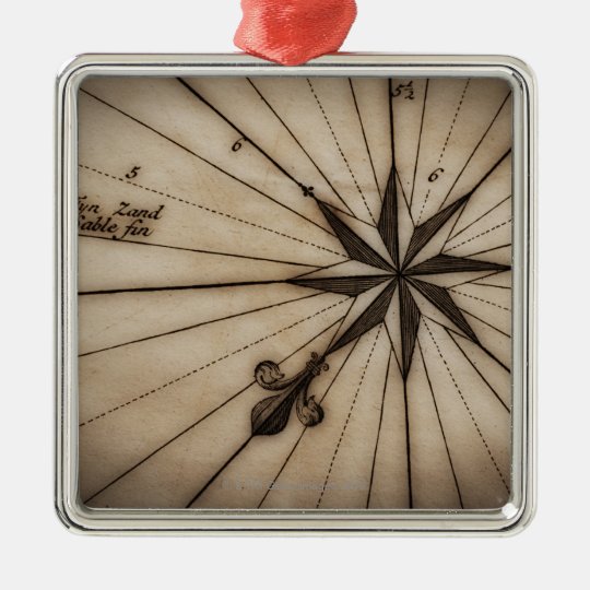 Close up of wind rose on antique map metal ornament