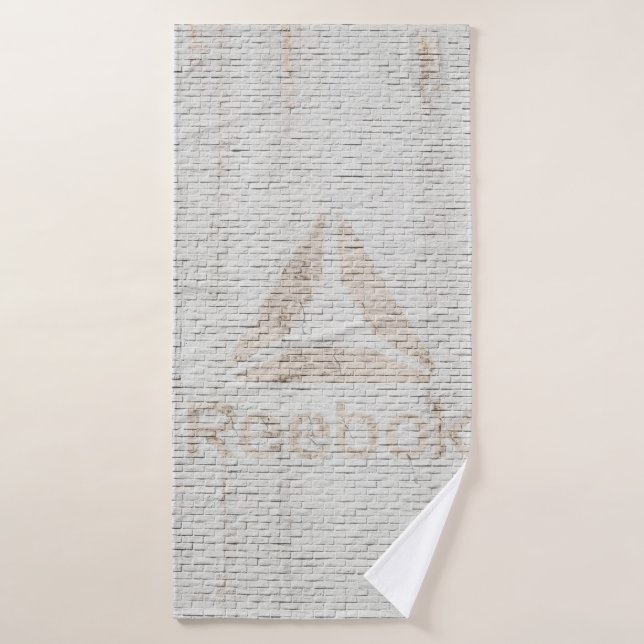 Close-up photo of Reebok logo on wall Bath Towel (Bath Towel)
