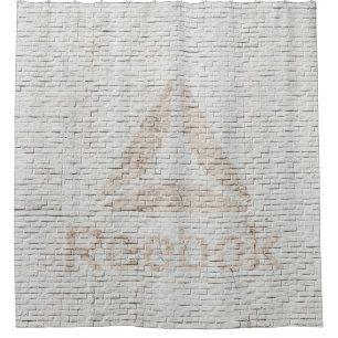 Close-up photo of Reebok logo on wall Shower Curtain