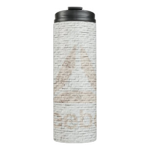 Close-up photo of Reebok logo on wall Thermal Tumbler