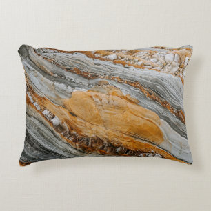 Close-up photography of gray and orange stones accent pillow