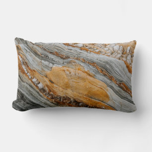 Close-up photography of gray and orange stones lumbar pillow